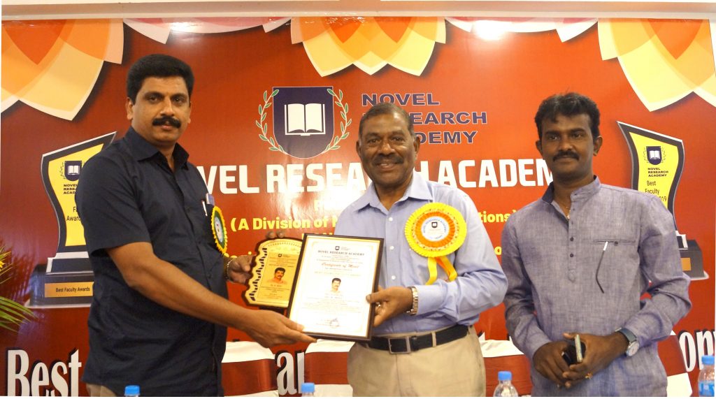Dr. Biju A. is receiving the Best Faculty Award from Minister of Environment , Pondichery  .
